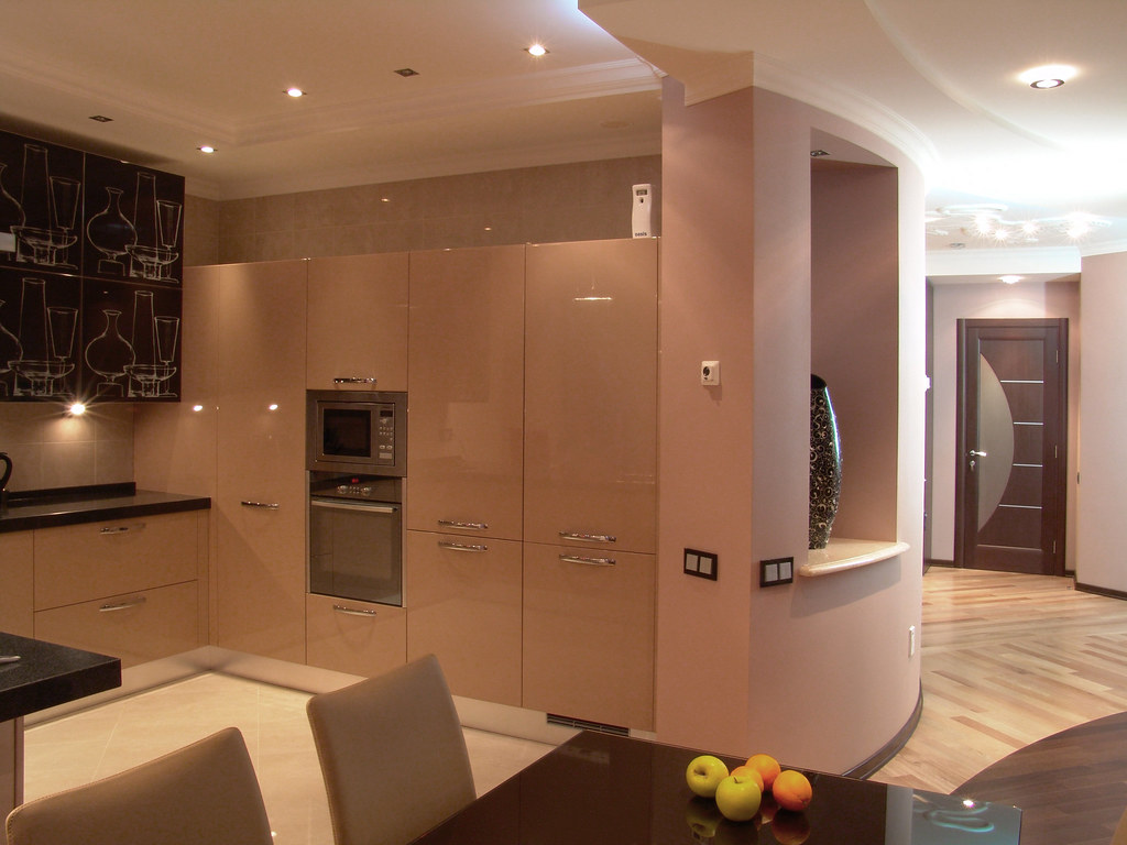 Modern kitchen with built-in appliances including oven and microwave